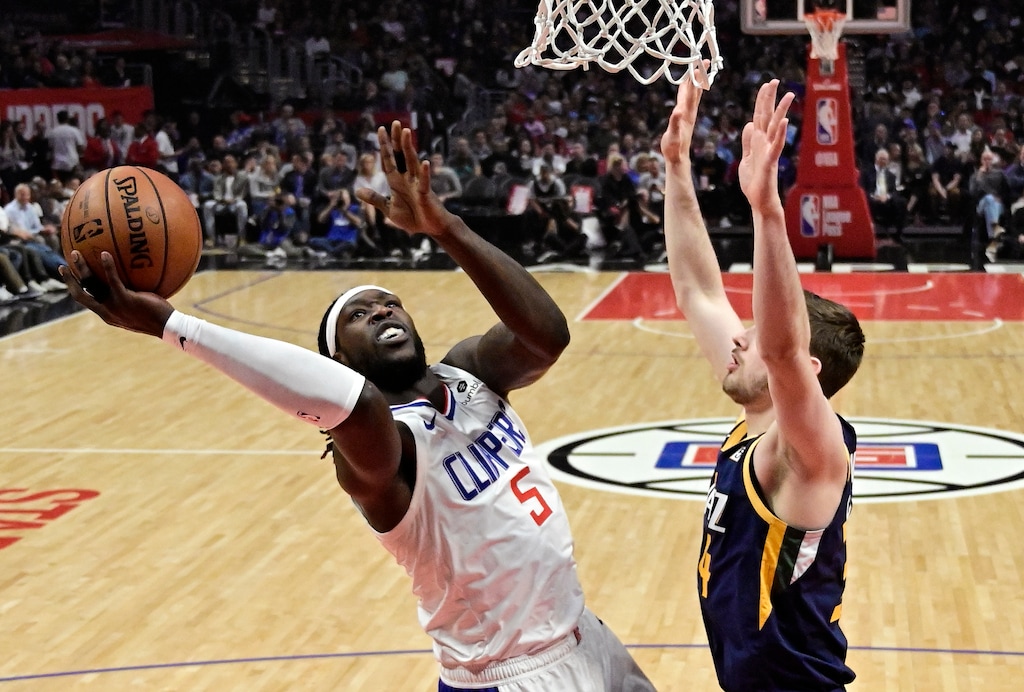 Los Angeles Clippers forward Montrezl Harrell, left, shoots as Utah Jazz forward Tyler Cavanaugh defends during the first half of an NBA basketball game Wednesday, April 10, 2019, in Los Angeles. (AP Photo/Mark J. Terrill)