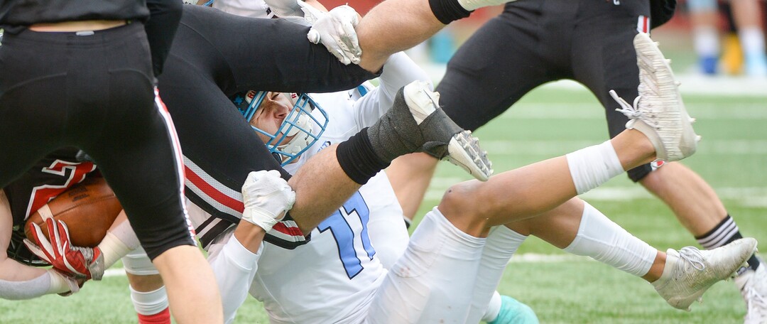 (Leah Hogsten  |  The Salt Lake Tribune) Park CityÕs Dylan Bauer is pulled down by Sky ViewÕs Sout Morris. Sky View High School defeated Park City 35-0 to win the 4A State Championship football title, Nov. 11, 2019 at Rice-Eccles Stadium.