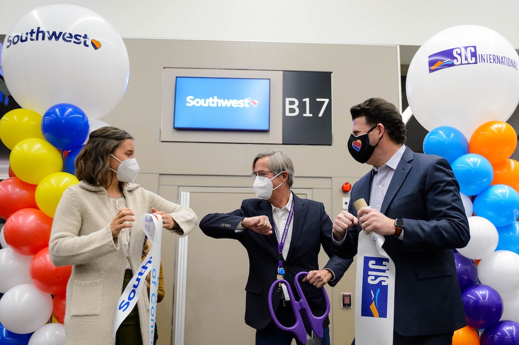 (Trent Nelson  |  Tribune file photo) Salt Lake City Mayor Erin Mendenhall, airport director Bill Wyatt, and Steve Sisneros of  Southwest Airlines bump elbows after cutting a ribbon at gate B17 as the Salt Lake City International Airport celebrates the opening of concourse B, with a Southwest flight to Oakland taking off on Tuesday, Oct. 27, 2020.