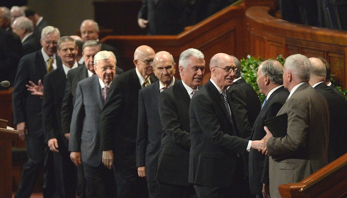 (Al Hartmann  |  The Salt Lake Tribune) 	
President Henry Eyring, first counselor to the First Presidency, fourth from right,, and President Dieter Uchtdorf, second counselor to the First Presidency, just behind, shake hands with the members of Qurom of the Twelve Apostles at concusion of the Sunday morning session of the LDS Church’s 187th Semiannual General Conference in Salt Lake City on Sunday Oct. 1.
