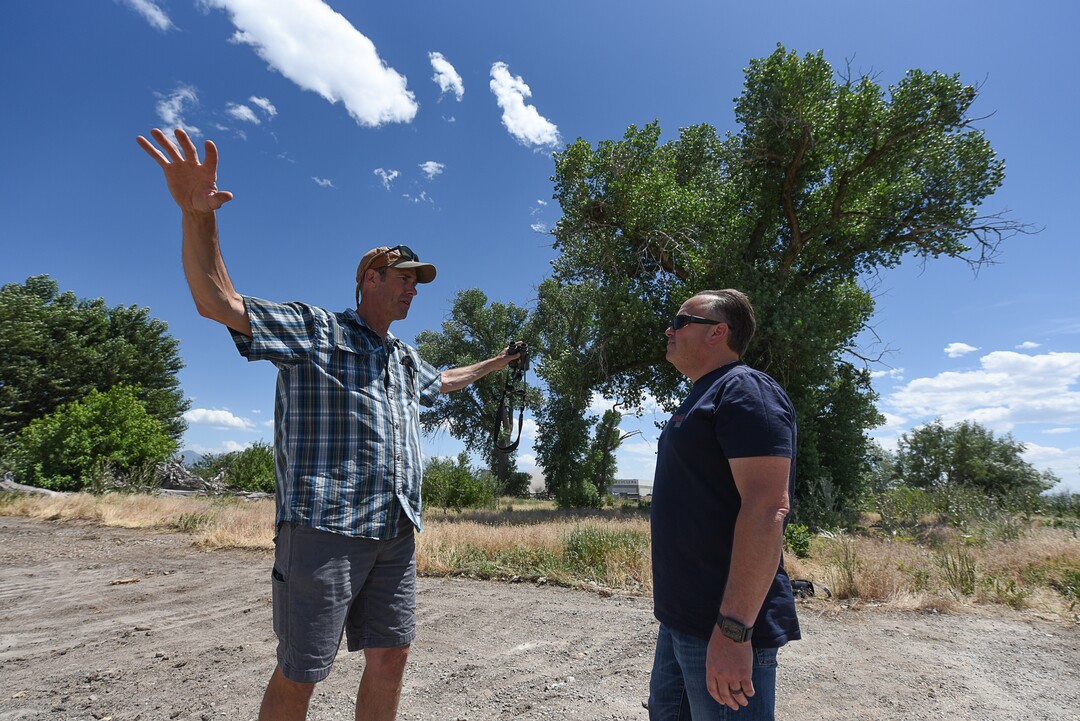 (Francisco Kjolseth  |  The Salt Lake Tribune)  Tim Begue, left, a self described birder since 1994, talks with Chris Mantas, the owner of All Truck & Car auto recycling who is constructing a new facility at 3255  W. 500 South. Mantas originally planned to rip out the large cottonwood trees in the background to make way for his new business. Neighbors persuaded him to save the habitat.