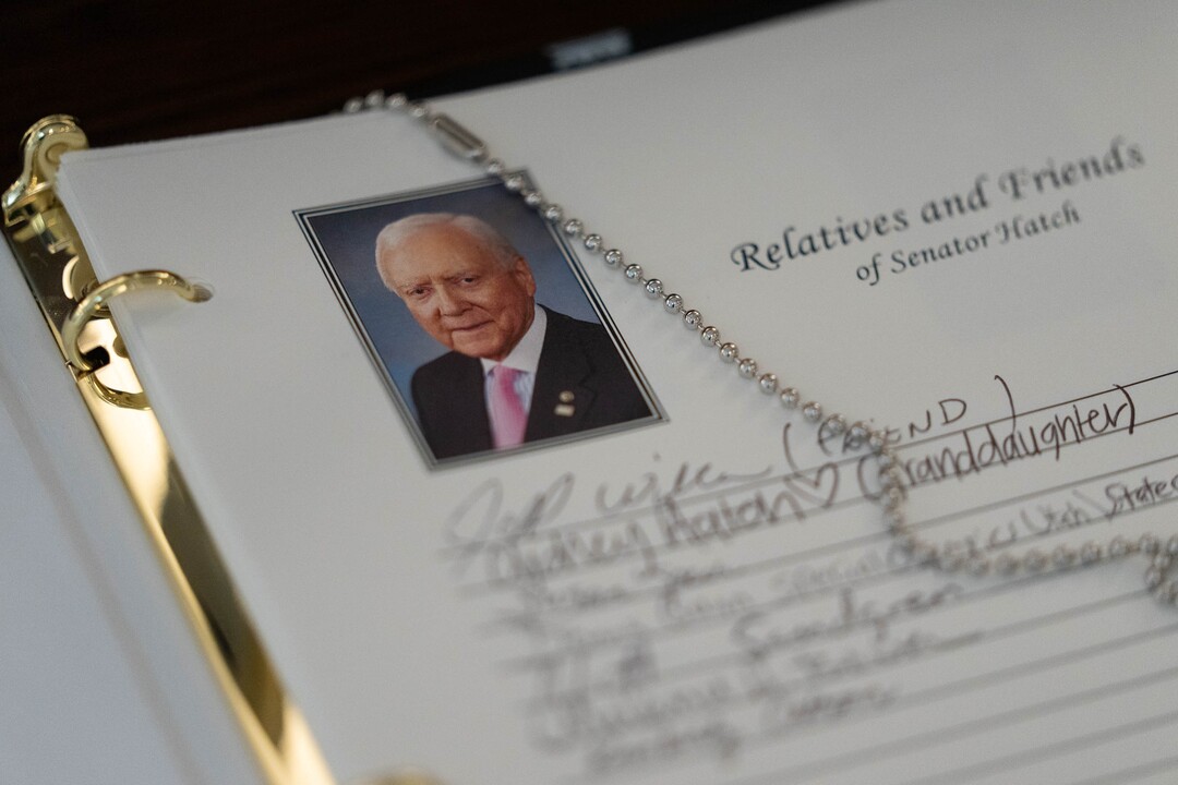 (Francisco Kjolseth | The Salt Lake Tribune) People sign the guest book as the casket carrying former U.S. Sen. Orrin Hatch lies at the Utah Capitol on Wednesday, May 4, 2022.