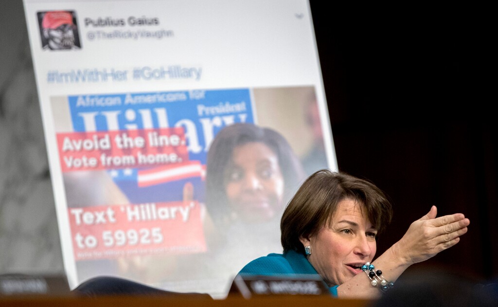 Sen. Amy Klobuchar, D-Minn., speaks next to a poster depicting an online ad that attempted to suppress voters as Facebook's General Counsel Colin Stretch, Twitter's Acting General Counsel Sean Edgett, and Google's Law Enforcement and Information Security Director Richard Salgado, testifies before a Senate Committee on the Judiciary, Subcommittee on Crime and Terrorism hearing on Capitol Hill in Washington, Tuesday, Oct. 31, 2017, on more signs from tech companies of Russian election activity. (AP Photo/Andrew Harnik)