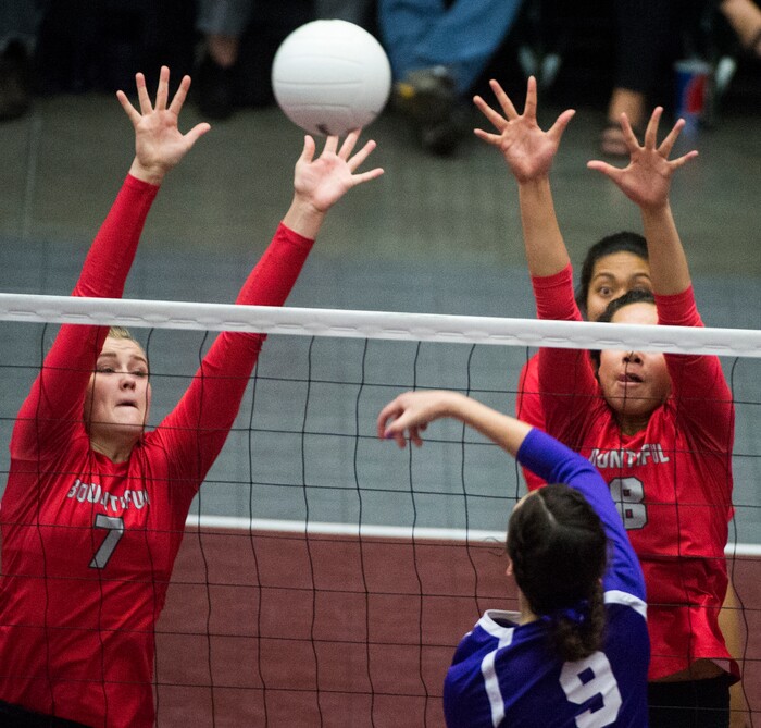 (Rick Egan  |  The Salt Lake Tribune)  Box Elder Bees Jaida Burt (9) hits the ball past  Bountiful Braves Baily Jenkins (7) and Kaybrie Pe’a (8), in 5A volleyball championship game, Bountiful vs. Box Elder, at Utah Valley University, Saturday, November 4, 2017.