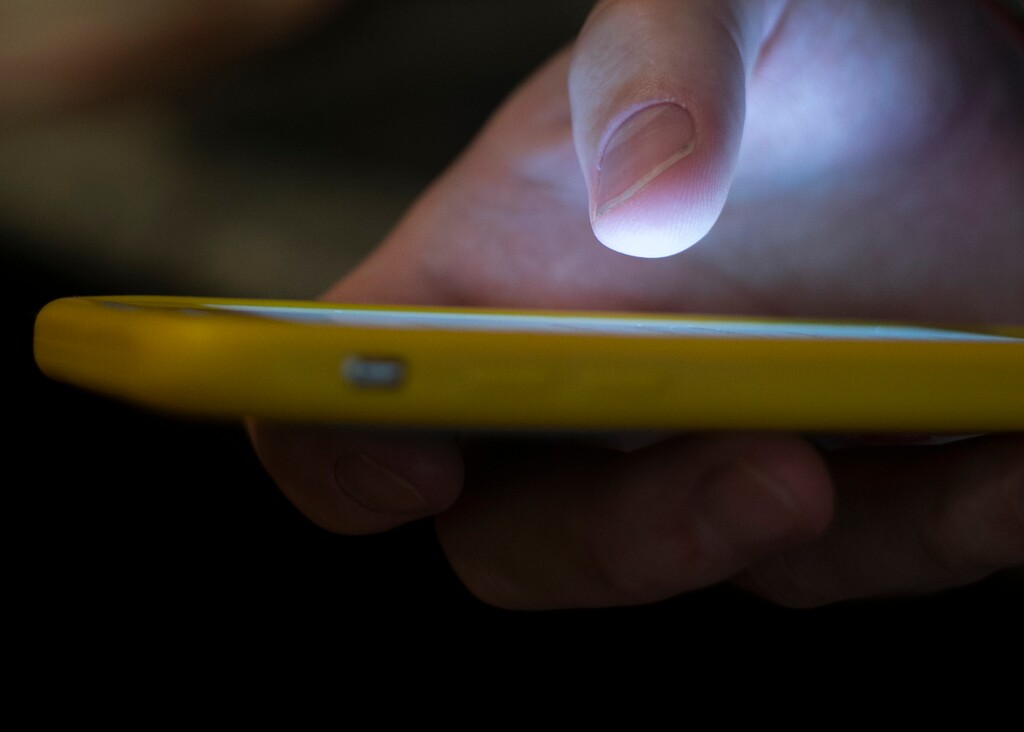 (Jenny Kane | AP) A man uses a cellphone in this Aug. 11, 2019, photo. Utahns who are experiencing a mental health crisis can now dial just three numbers — 988 — to get help from the National Suicide Prevention Lifeline.