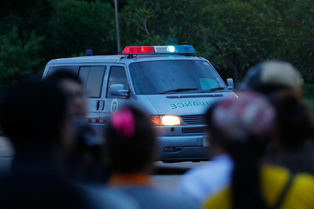 An ambulance believed to be carrying one of the rescued boys from the flooded cave heads to the hospital in Chiang Rai as divers continue to extract the remaining boys and their coach trapped at Tham Luang cave in the Mae Sai district of Chiang Rai province, northern Thailand, Tuesday, July 10, 2018. Thai Navy SEALs say all 12 boys and their coach were rescued from the cave, ending an ordeal that lasted more than 2 weeks. (AP Photo/Vincent Thian)