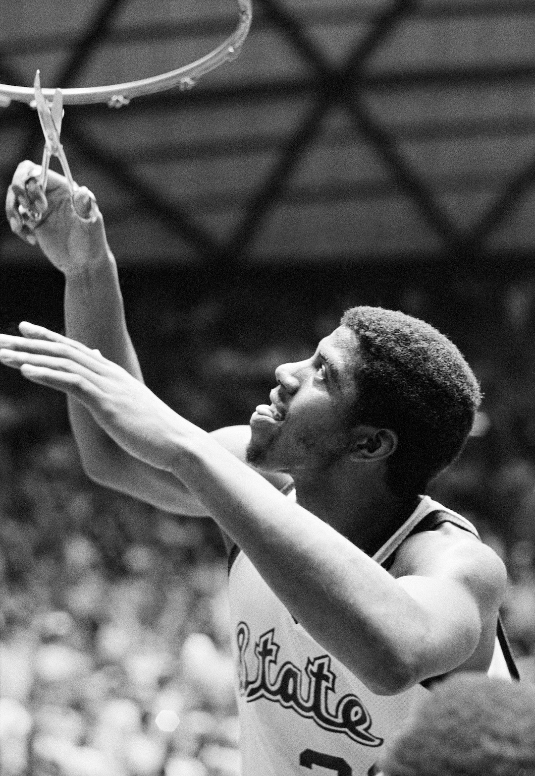 (AP Photo) Earvin "Magic" Johnson of Michigan State participates in victory ceremonies as the net comes down after they defeated Indiana State 75-64 to win the NCAA champion Monday, March 26, 1979 in Salt Lake City. Johnson was named the tournament's most valuable player. 