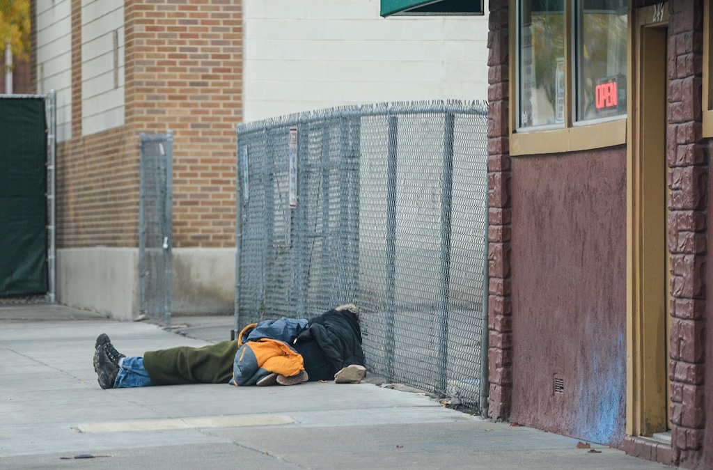 (Francisco Kjolseth  |  The Salt Lake Tribune)  A homeless man sleeps on the sidewalk near the newly fenced off area along Rio Grande St. in Salt Lake on Friday, Nov. 3, 2017.