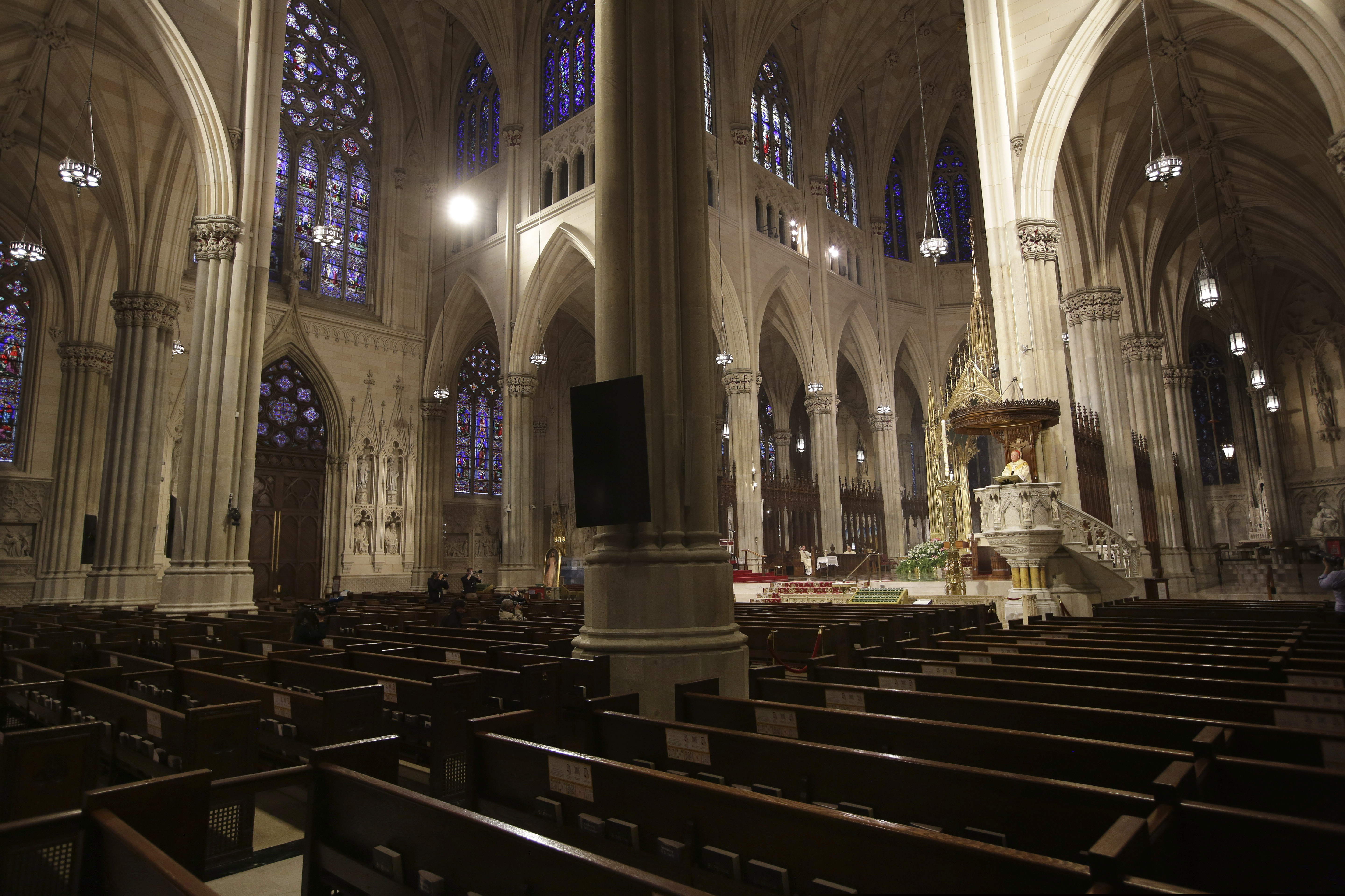 (AP Photo/Seth Wenig) In this Sunday, April 12, 2020, file photo, Cardinal Timothy Dolan, right, delivers his homily over mostly empty pews at St. Patrick's Cathedral in New York due to coronavirus concerns. During the 1990s, statistics show, large amounts of young people left religion.