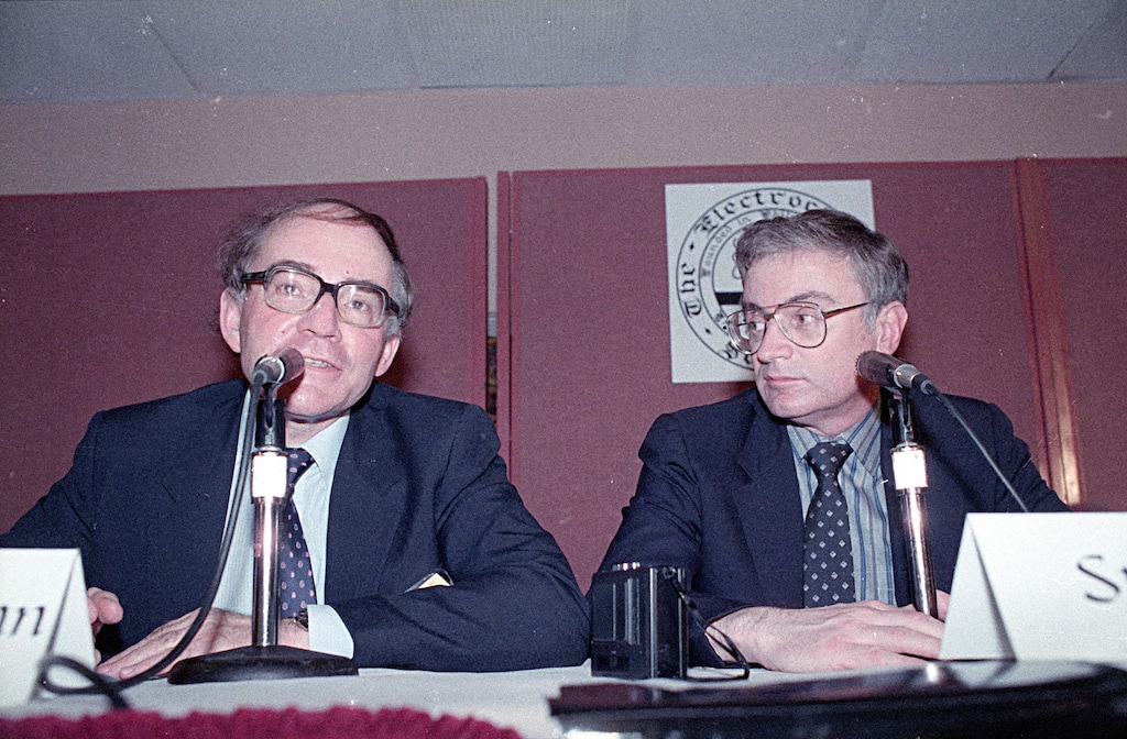 (Doug Pizac | AP) Martin Fleischmann, left, of the University of Southampton, England, talks to reporters about cold fusion as University of Utah chemist B. Stanley Pons listens in Los Angeles, May 9, 1989. The pair of scientists claimed they achieved nuclear fusion, but that claim could never be proven and the university was widely ridiculed.