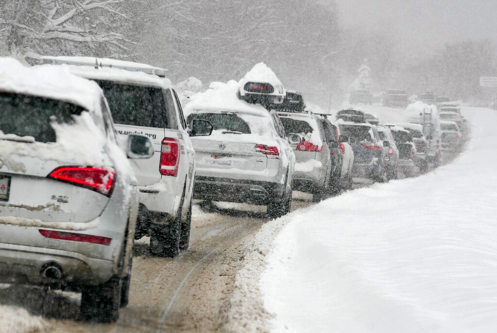 (Francisco Kjolseth | The Salt Lake Tribune) A long line of cars forms near Little Cottonwood Canyon during the snow storm on Wednesday, Feb. 22, 2023.
