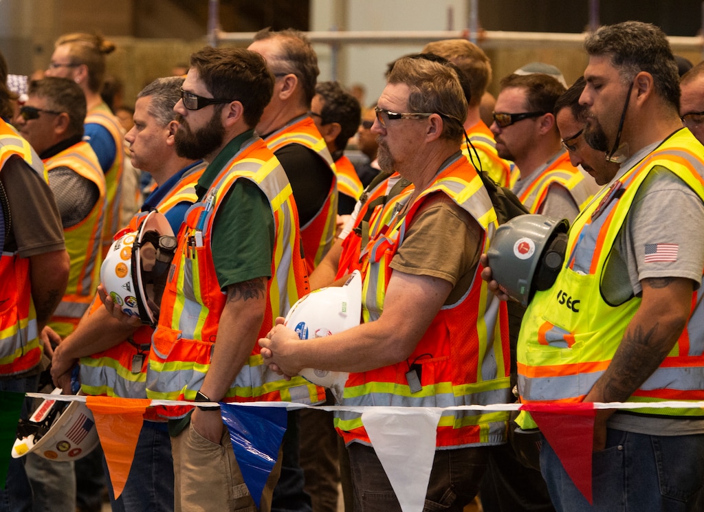 (Rick Egan | Tribune file phto) Construction workers pause for a moment of silence, as they gather at the site of the new terminal at the Salt Lake International Airport, for a 9-11 remembrance event on Sept. 11, 2019.