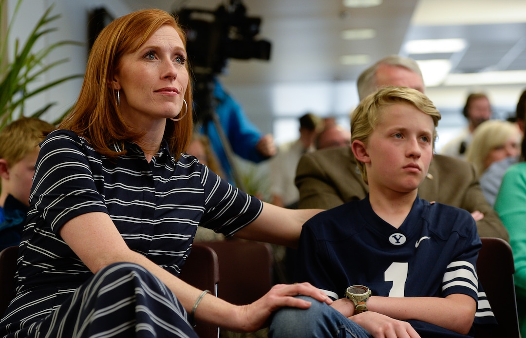 (Francisco Kjolseth  |  The Salt Lake Tribune)  Jennie Taylor embraces his son Lincoln, 12, as they listen to the musical vocal trio Gentri perform "One" as Brigham Young University honors the life and legacy of Major Brent Taylor, former mayor of North Ogden and a BYU Army ROTC alumnus during a ceremony at the Wilkinson Student Center Reflection RoomÕs Memorial Wall in Provo on Thursday, May 23, 2019. The BYU Army ROTC also unveiled the updated Memorial Wall, a list of BYU students and alumni who have in service which now includes Major TaylorÕs name.