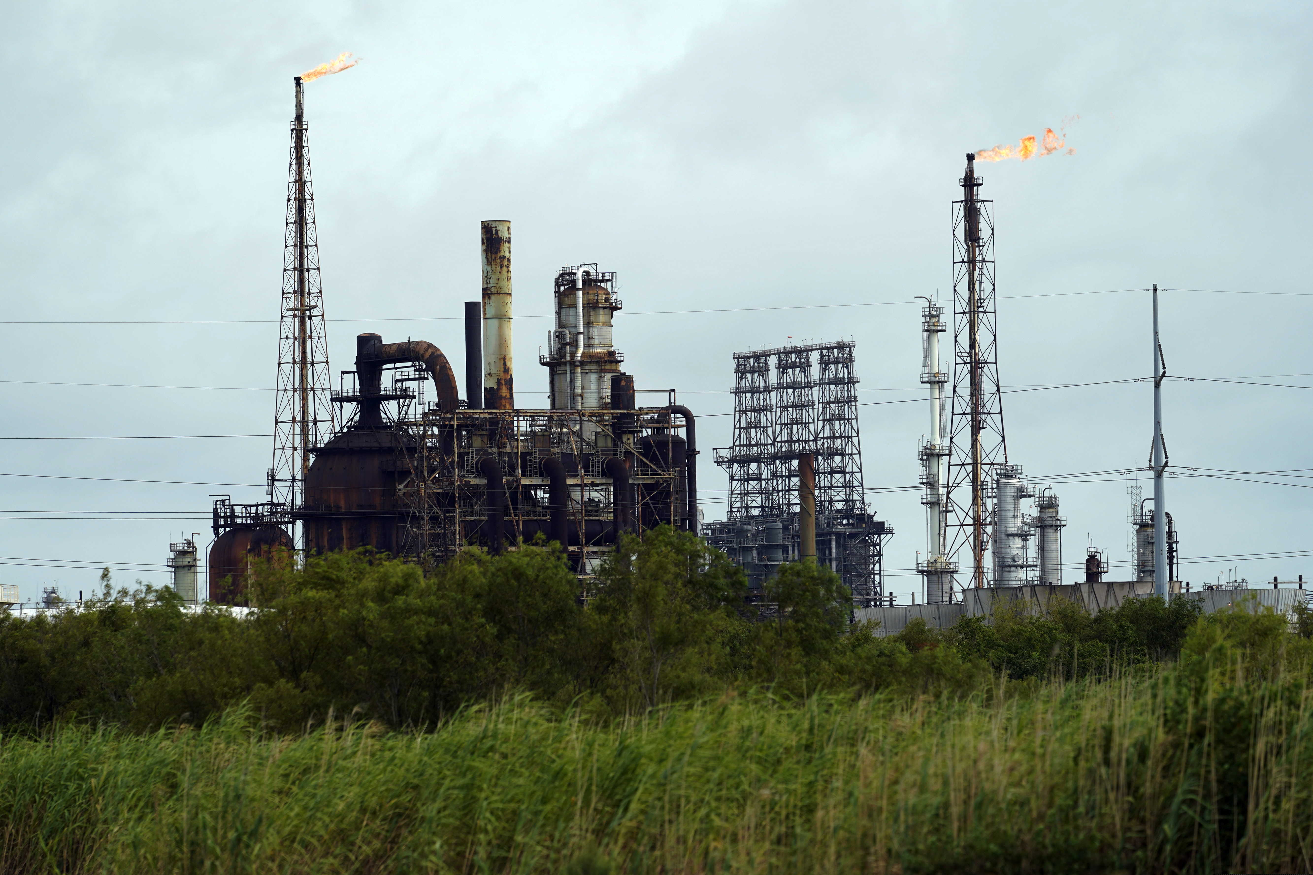 Winds blow the flames at refinery, Wednesday, Aug. 26, 2020, in Port Arthur, Texas. The energy industry is bracing for catastrophic storm surges and winds as Hurricane Laura cuts a dangerous path toward the coastlines of Texas and Louisiana.(AP Photo/Eric Gay)