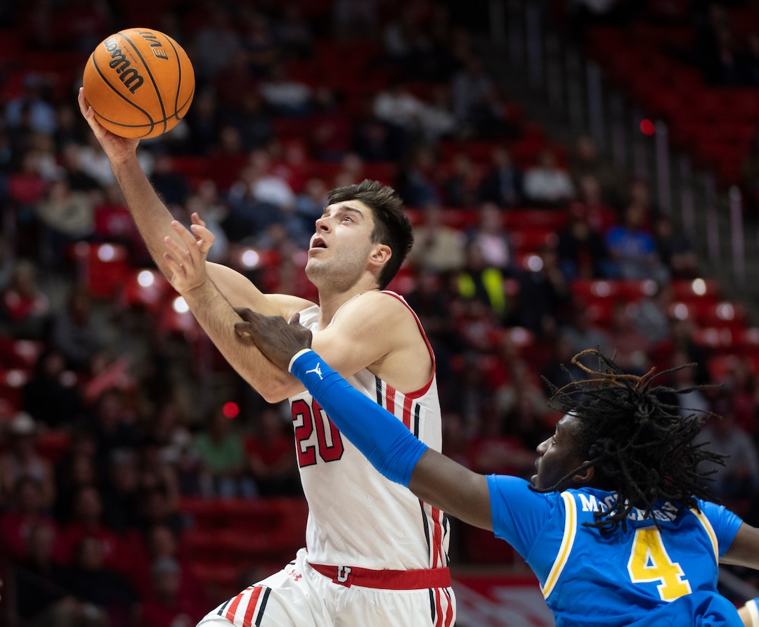 (Rick Egan | The Salt Lake Tribune) Utah Utes guard Lazar Stefanovic (20) goes to the hoop, as UCLA guard Will McClendon (4) defends for the Bruins, in PAC-12 basketball action between Utah Utes and UCLA Bruins, at the Jon M.Huntsman Center, Thursday, February. 23, 2022.