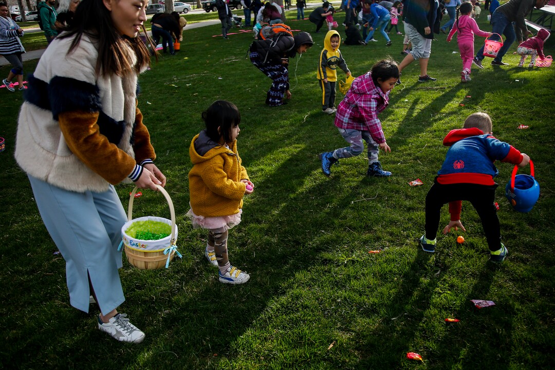 (Nicole Boliaux  |  For The Tribune)  Children and their families run to grab Easter eggs during the annual Easter egg hunt put on by A Kid's Place Dentistry in Liberty Park in Salt Lake City on Saturday, March 31, 2018.