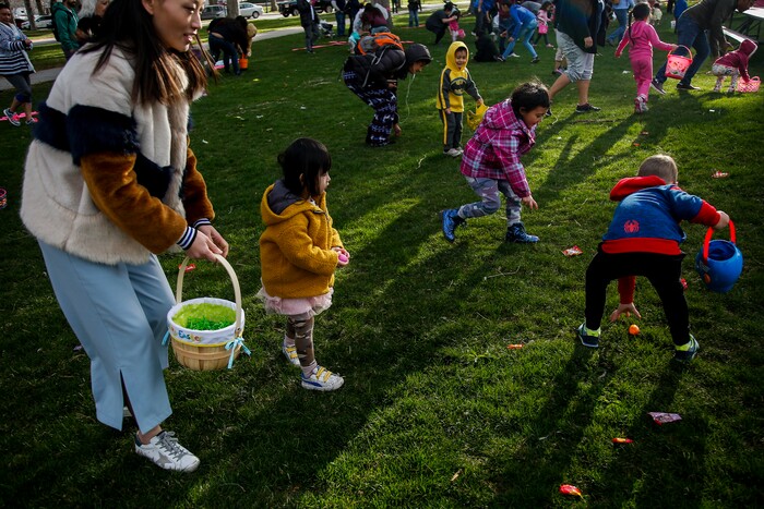 (Nicole Boliaux | For The Tribune) Children and their families run to grab Easter eggs during the annual Easter egg hunt put on by A Kid's Place Dentistry in Liberty Park in Salt Lake City on Saturday, March 31, 2018.