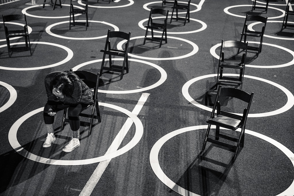 (Damon Winter | The New York Times)

A staff member for the Biden campaign sits among physically-distanced chairs before an election night rally at the Westin Hotel in Wilmington, Del., on Tuesday, Nov. 3, 2020. "We might be able to achieve normalcy by summer. Our leaders should embrace the possibility," writes New York Times opinion columnist Ross Douthat.