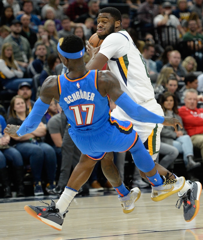 (Francisco Kjolseth  |  The Salt Lake Tribune)  Utah Jazz guard Emmanuel Mudiay (8) collides with Oklahoma City Thunder guard Dennis Schroder (17) as the Utah Jazz host the Oklahoma City Thunder in their NBA basketball game at Vivint Smart Home Arena in Salt Lake City on Mon. Dec. 9, 2019.