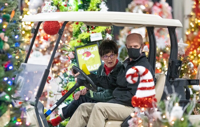 (Francisco Kjolseth | The Salt Lake Tribune) Patti Peterson of Las Vegas who has terminal cancer, joins her husband Clay as they tour the 51st annual Festival of Trees on Tuesday Nov. 30. 2021, at the Mountain America Expo Center in Sandy. Peterson who is passionate about Primary Children’s Hospital and their treatment of kids wished to have the Elf Emporium storefront, built by her family, donated in her name. “My cancer journey has been joyful because I wasn’t always thinking about myself.”