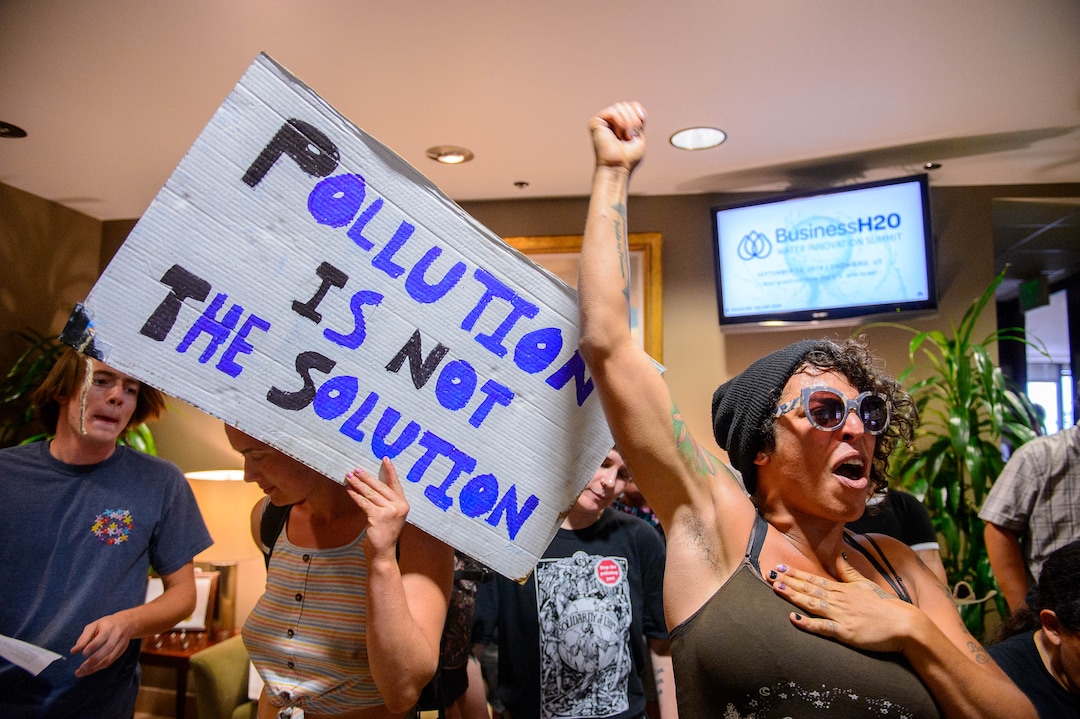 (Trent Nelson  |  The Salt Lake Tribune) Protesters occupy the Chamber of Commerce office in Salt Lake City on Tuesday, July 9, 2019. Dozens of people showed up to protest the proposed Inland Port and ended up clashing with police, resulting in temporary street closures and arrests.