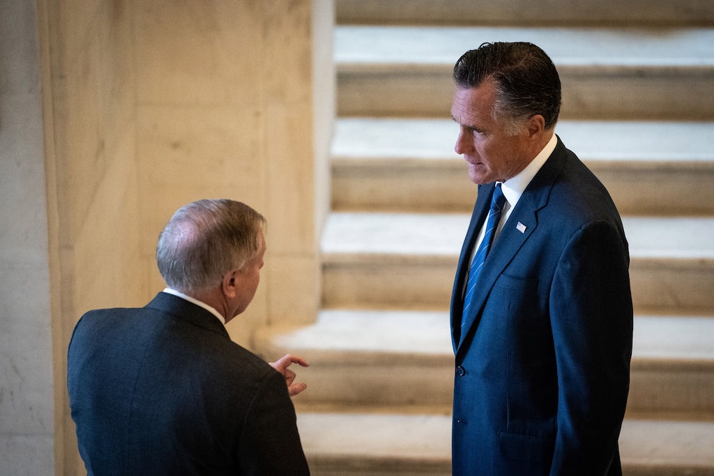 (Erin Schaff | New York Times file photo)  Sen. Lindsey Graham (R-S.C) talks with Sen. Mitt Romney (R-Utah) on Capitol Hill in Washington, March 18, 2020.