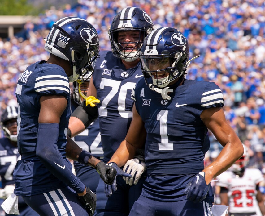 (Rick Egan | The Salt Lake Tribune) Brigham Young Cougars wide receiver Darius Lassiter (5) Brigham Young Cougars offensive lineman Connor Pay (70) and wide receiver Keanu Hill (1) celebrate Lassiter's touchdown, in football action a between the Southern Utah Thunderbirds and the Brigham Young Cougars, at LaVell Edwards Stadium, on Saturday, Sept. 9, 2023.