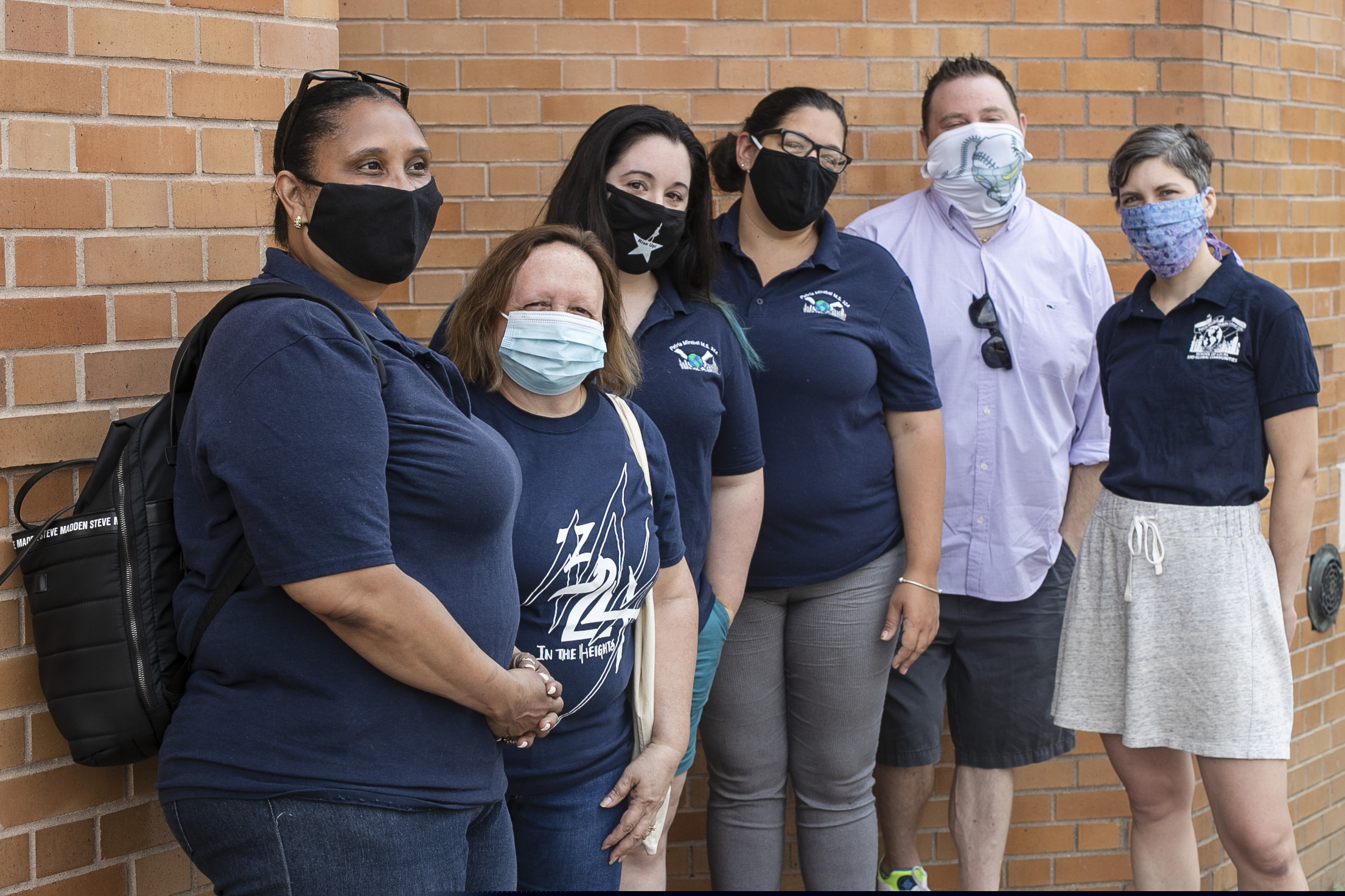 (Frank Franklin II | AP) Teacher Lisa Fitzgerald O'Connor, third from left, poses for photographs with colleagues Luz Jimenez, left, Maria Damas, second from left, Meagan Hammerbacher, United Federation of Teachers chapter leader Shawn Hindez, second from right, and Sarah Kuhner, right, at M.S. 324 Thursday, Aug. 6, 2020, in New York. It has been seven years since the central air conditioning system worked at the New York City middle school where they teach. As a new school year approaches amid the coronavirus pandemic, O'Connor and her colleagues are threatening not to return unless it's repaired.