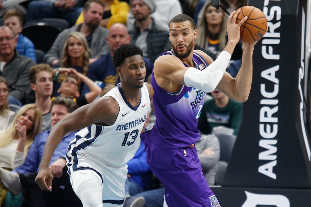 Utah Jazz center Rudy Gobert (27) grabs a rebound from Memphis Grizzlies forward Jaren Jackson Jr. (13) during the first half of an NBA basketball game Saturday, Dec. 7, 2019, in Salt Lake City. (AP Photo/George Frey)