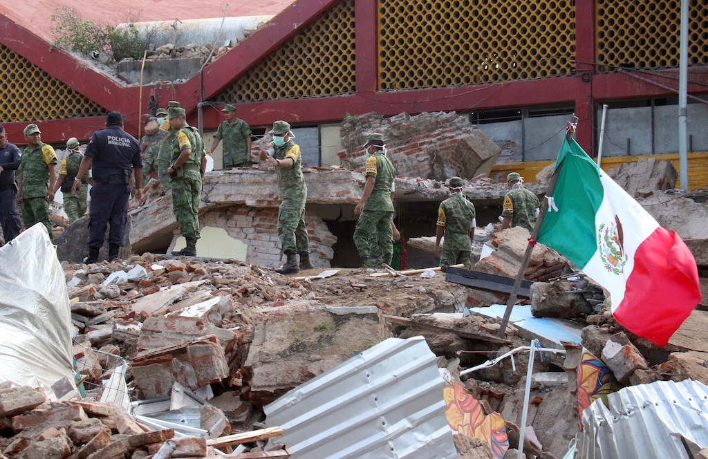 Soldiers remove debris from a partly collapsed municipal building felled by a massive earthquake in Juchitan, Oaxaca state, Mexico, Friday, Sept. 8, 2017. One of the most powerful earthquakes ever to strike Mexico has hit off its southern Pacific coast, killing at least 32 people, toppling houses, government offices and businesses. (AP Photo/Luis Alberto Cruz)