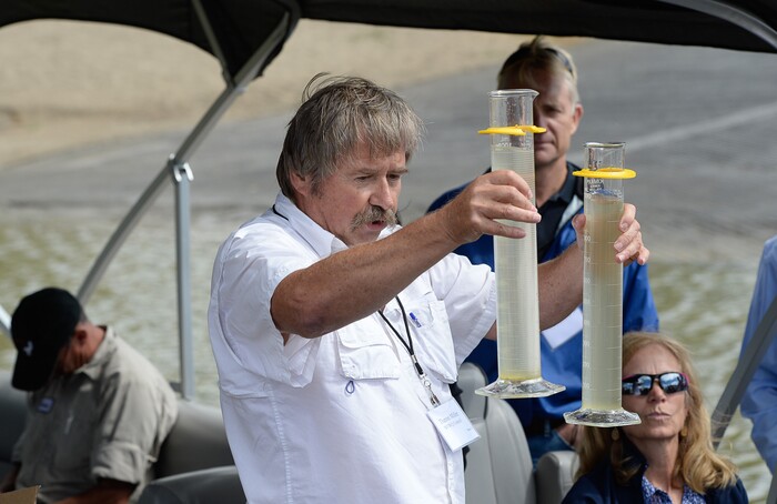 (Francisco Kjolseth | The Salt Lake Tribune) Theron Miller of the Wasatch Front Water Quality Council shows the difference seen in samples of Utah Lake water after treating one with Aluminum Sulfate that has been shown to treat against elevated phosphorus and algae blooms. Members of the Legislative Water Development Commission gathered before a tour of Utah Lake on Wednesday, Sept. 13, 2017, for the purpose of learning of wastewater treatment, the importance of protecting our lakes and rivers, how the state is looking to change water quality standards and how regulation is an important local issue.