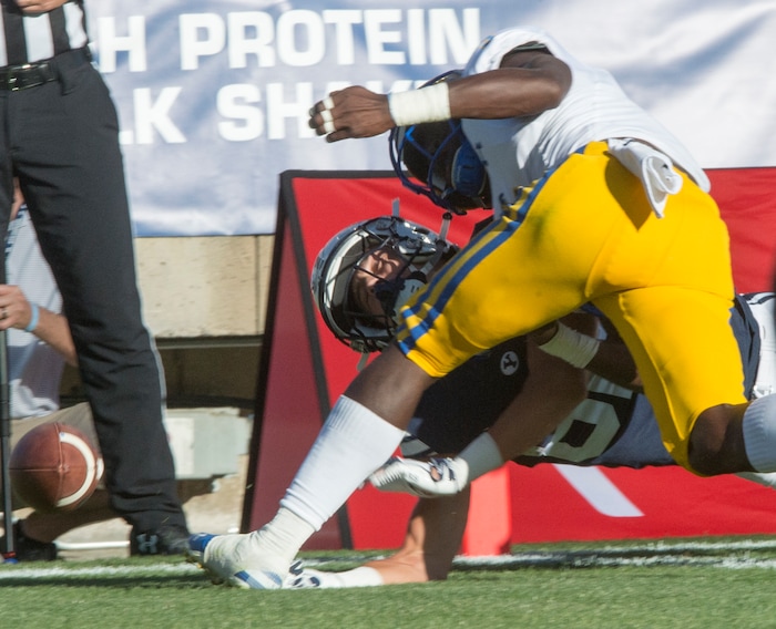 (Rick Egan  |  The Salt Lake Tribune)    Holker (32) gets hit hard by McNeese State Cowboys defensive back Jovon Burriss (5), but was not called for targeting after the replay, in football action Brigham Young Cougars vs McNeese State Cowboys at Lavell Edwards Stadium, Saturday, Sept. 22, 2018.


