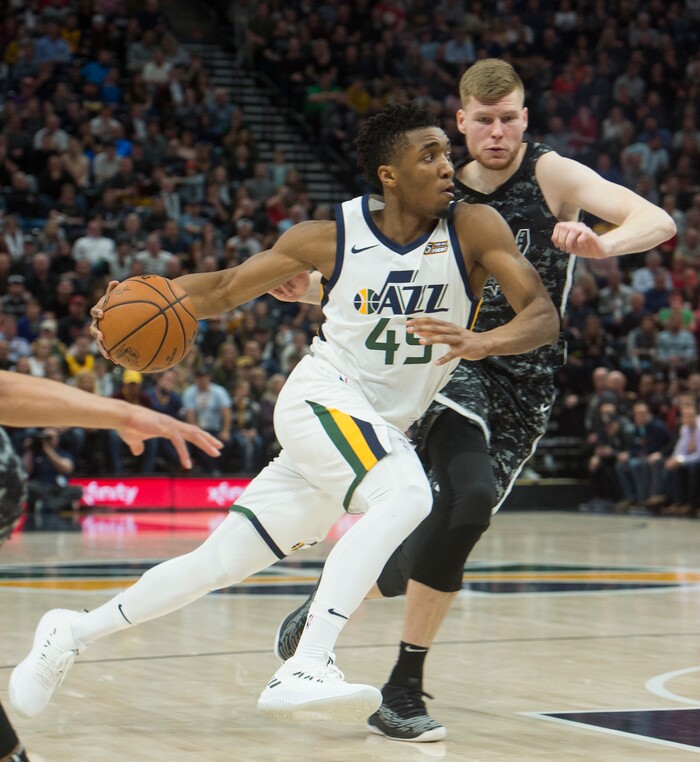 (Rick Egan  |  The Salt Lake Tribune)   Utah Jazz guard Donovan Mitchell (45) takes the ball in side as he gets past San Antonio Spurs forward Davis Bertans (42), in NBA action, in Salt Lake City, Monday, February 12, 2018.