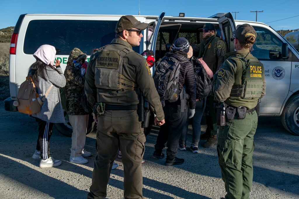 (Guillermo Arias | The New York Times) Asylum seekers and migrants board a Border Patrol vehicle in Boulevard, Calif., on Feb. 13, 2024. Here's what candidates in Utah's 2024 gubernatorial race think the role of the governor should be in immigration policy.