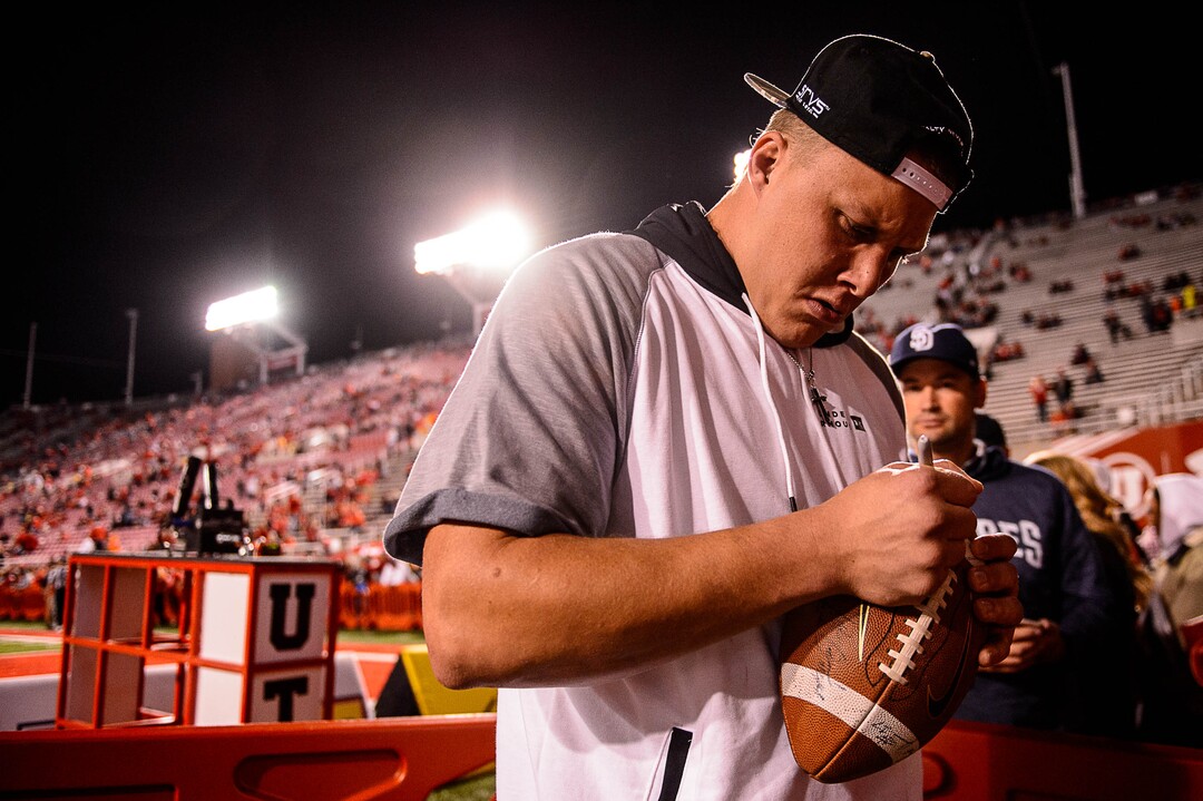 (Trent Nelson | The Salt Lake Tribune)  Garett Bolles signs a football as the University of Utah hosts Stanford, NCAA football at Rice-Eccles Stadium in Salt Lake City Saturday October 7, 2017.