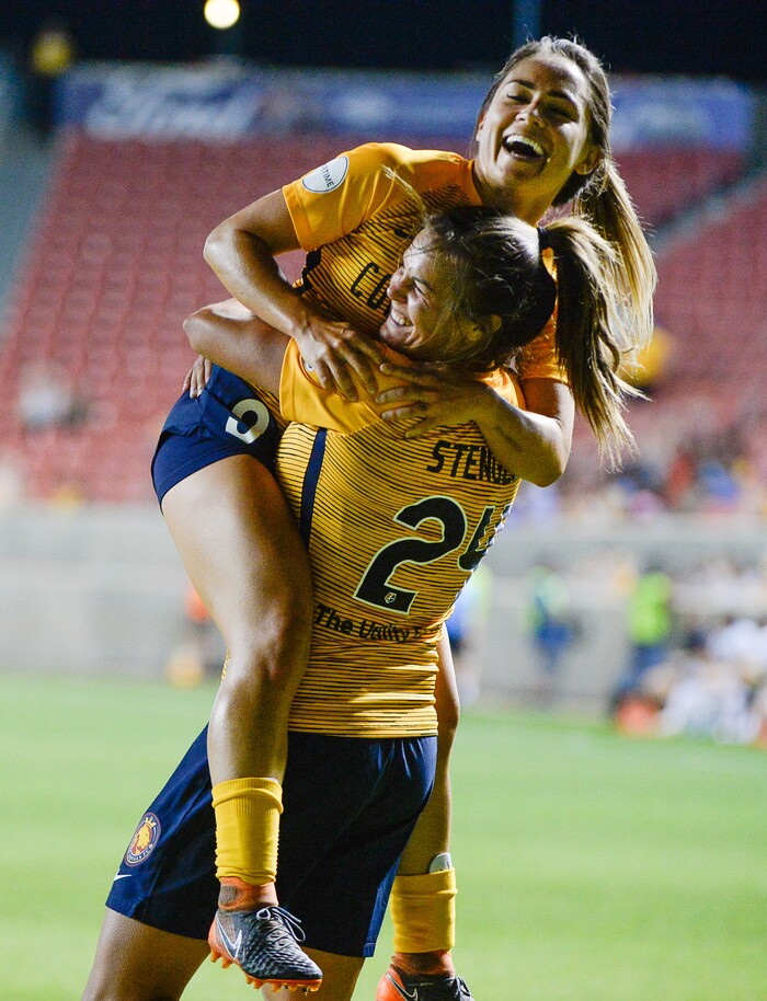 (Francisco Kjolseth  |  The Salt Lake Tribune)  Utah Royals FC hosts Washington Spirit, NWSL soccer at Rio Tinto Stadium in Sandy, Wed. Aug. 8, 2018. Utah Royals FC midfielder Lo'eau LaBonta (9) jumps on Utah Royals FC forward Katie Stengel (24) after Stegel's goal in the final minutes of the game. 