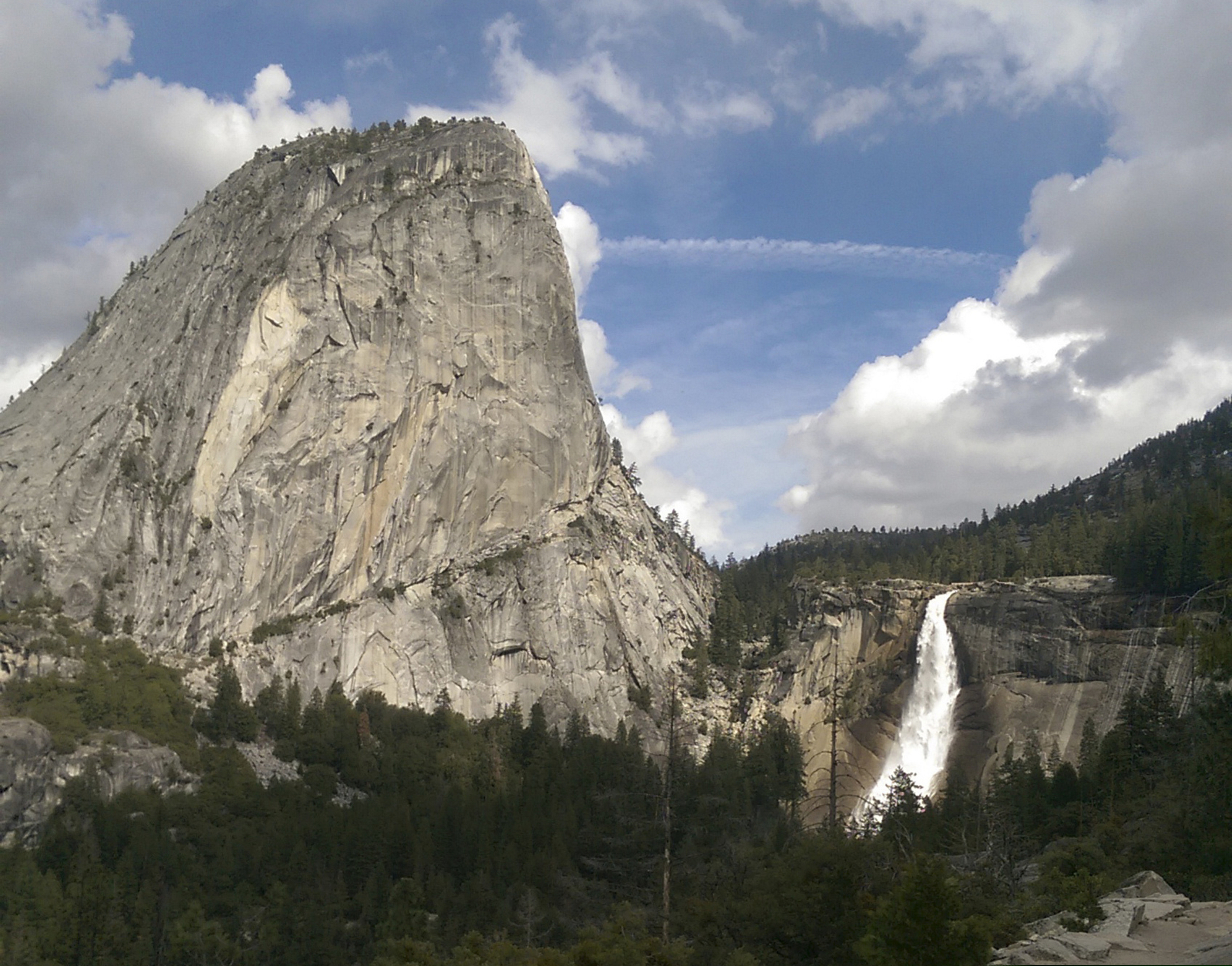 (National Park Service via AP, File) In this March 28, 2016, file photo provided by the National Park Service, water flows over the Nevada Fall near Liberty Cap as seen from the John Muir Trail in Yosemite National Park, Calif. The National Park Service says a man died after falling into a river at Yosemite National Park on Christmas Day. A government spokesman says rangers responding to a 911 call arrived on scene in less than an hour and provided medical aid, but the man died from a head injury. The park says an investigation into the death is taking longer than usual because of the partial government shutdown.