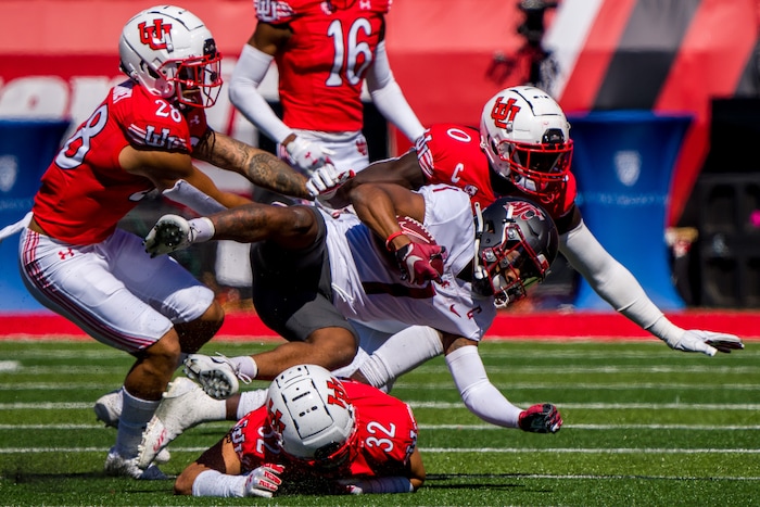 (Trent Nelson  |  The Salt Lake Tribune) Utah defenders stop Washington State Cougars wide receiver Travell Harris (1)  as the University of Utah hosts Washington State, NCAA football in Salt Lake City on Saturday, Sept. 25, 2021.