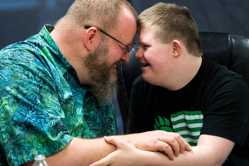 (Chris Detrick  |  The Salt Lake Tribune)  Chad Blythe and his son Logan, 15, embrace during an interview at VF Law in Salt Lake City, Friday, March 16, 2018.