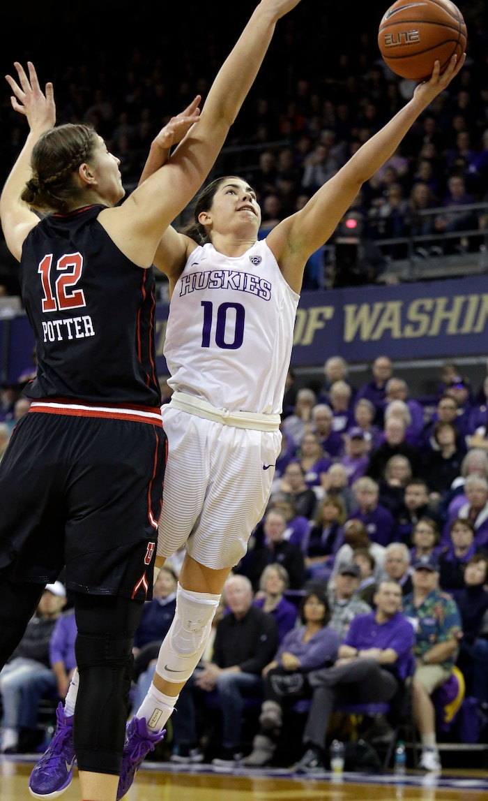Washington's Kelsey Plum (10) shoots as Utah's Emily Potter defends in the second half of an NCAA college basketball game Saturday, Feb. 25, 2017, in Seattle. (AP Photo/Elaine Thompson)