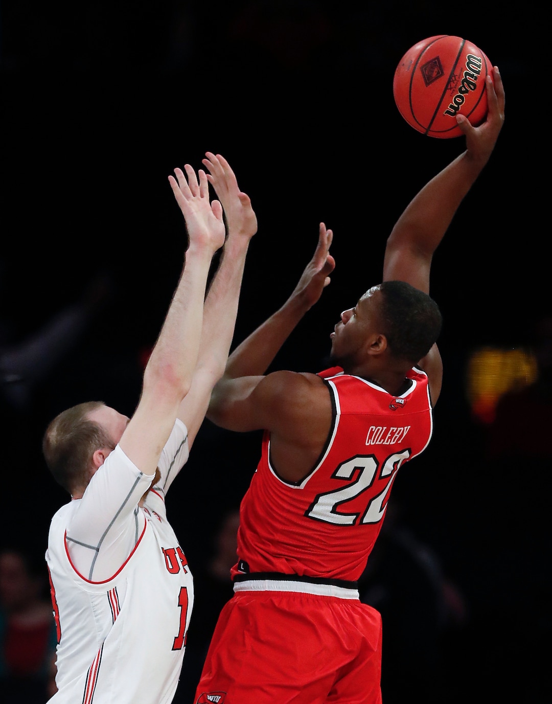 Western Kentucky forward Dwight Coleby (22) shoots over Utah forward David Collette during the first half of an NCAA college basketball game in the semifinals of the NIT, Tuesday, March 27, 2018, in New York. (AP Photo/Julie Jacobson)