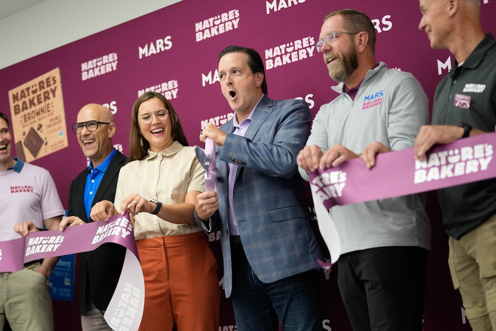 (Francisco Kjolseth | The Salt Lake Tribune) Salt Lake City Mayor Erin Mendenhall is flanked by Blas Maquivar, Global President of Health & Wellness Division Mars Snacking, left, and Nature’s Bakery CEO Steve Gardiner for a ribbon cutting of a new Manufacturing plant in Salt Lake City on Wednesday, July 30, 2025.