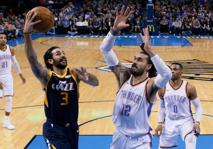 Utah Jazz guard Ricky Rubio (3) shoots in front of Oklahoma City Thunder center Steven Adams (12) in the first quarter of an NBA basketball game in Oklahoma City, Tuesday, Dec. 5, 2017. (AP Photo/Sue Ogrocki)