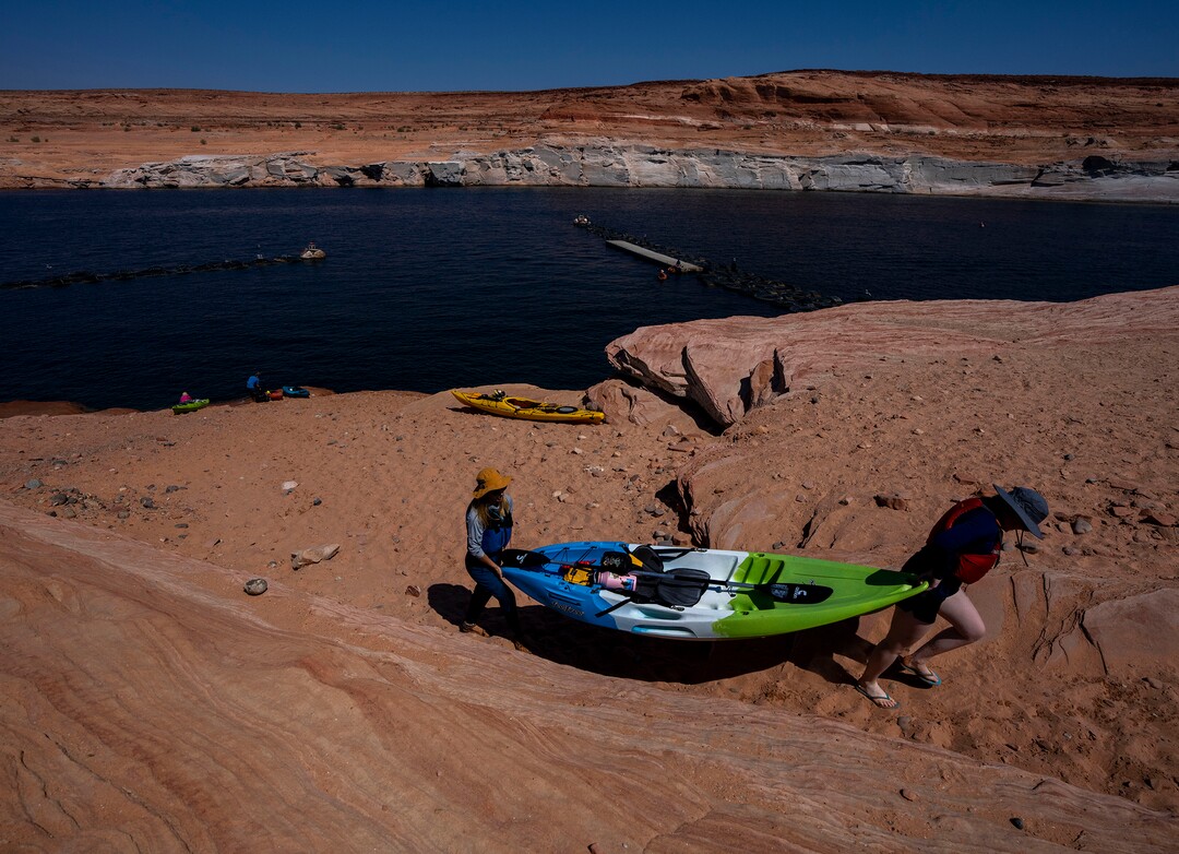 (Rick Egan | The Salt Lake Tribune)  Due to the low water levels, Jessie Pulliam, and Harper van Doorm haul their kayak up the hill at the Antelope Public Launch Ramp at Lake Powell, on Tuesday, Aug. 3, 2021.