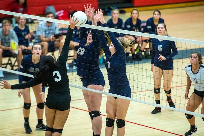 (Chris Detrick | The Salt Lake Tribune) Skyline's Anna Pingree (7) and Skyline's Cameron Mooney (26) block West's Sarona Snuka (3) during the volleyball match at West High School Tuesday, October 3, 2017.
