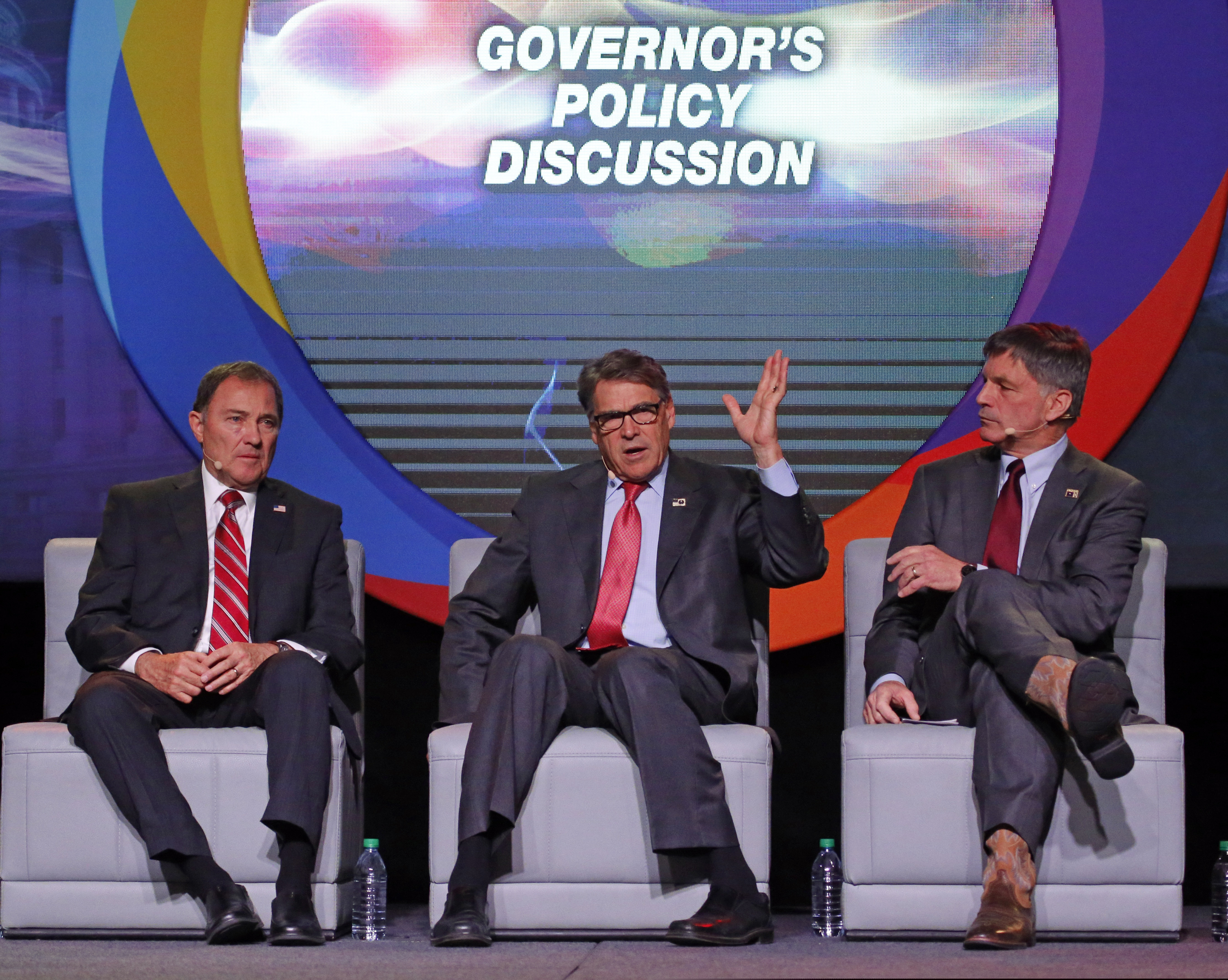 (Rick Bowmer | AP) U.S. Energy Secretary Rick Perry, center, speaks as Utah Gov. Gary Herbert, left, and and Wyoming Gov. Mark Gordon, right, look on at an energy summit Thursday, May 30, 2019, in Salt Lake City.