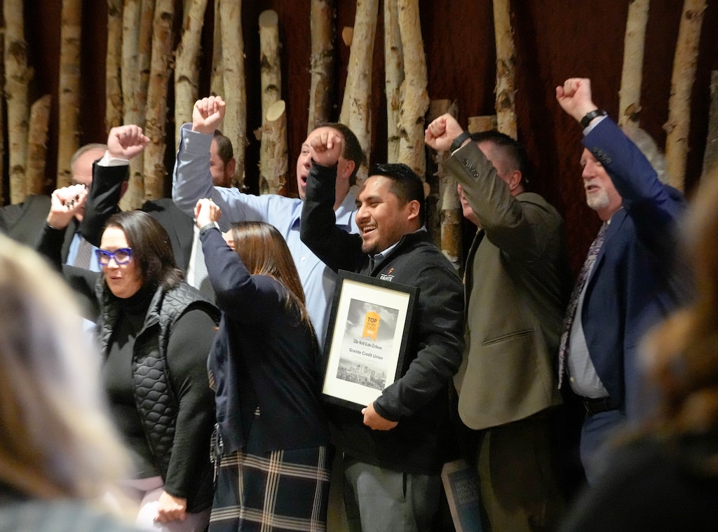 (Francisco Kjolseth | The Salt Lake Tribune) Granite Credit Union employees gathered for a group photo with their Top Workplaces award in 2022. Employees at Top Workplaces say they enjoy environments that prioritize inclusivity, support and teamwork.