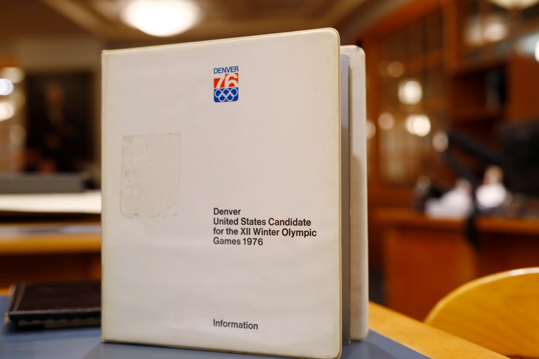 In this Feb. 1, 2018, photo, a binder filled with information used in Colorado's effort to secure an Olympic bid in 1976 is part of the memorabilia collection of the Denver Public Library in Denver. Over 40 years after becoming the first city to walk away from an Olympic bid, Denver is considering whether to try to again to host the Winter Games. (AP Photo/David Zalubowski)