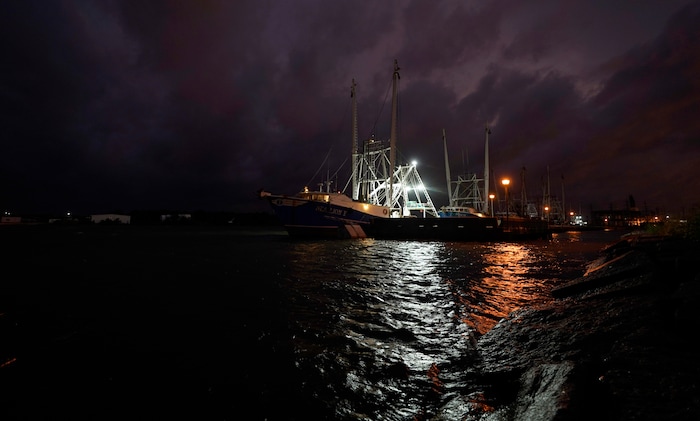 Crew members of a shrimp boat called the Sea Lion V prepare as they wait for Hurricane Laura to make landfall, Wednesday, Aug. 26, 2020, in Port Arthur, Texas. (AP Photo/Eric Gay)