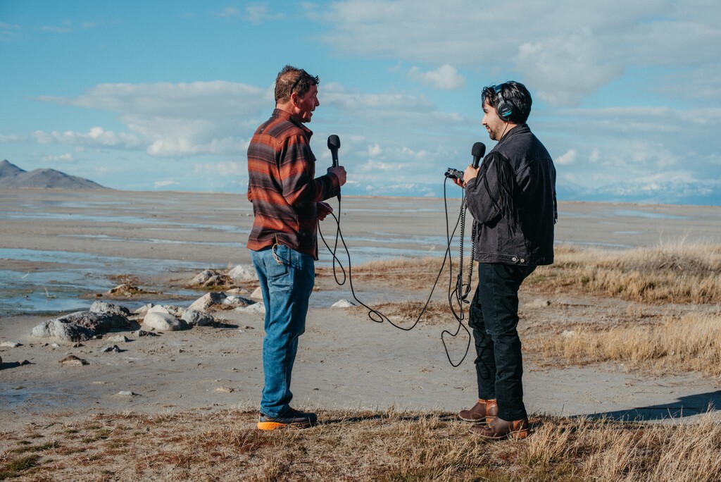 (Jeri Gravlin) Meisei Gonzalez, right, co-host of the podcast "Stay Salty: Lakefacing Stories," interviews Jim Hopkins, discussing the magic of sunrises and sunsets reflecting on Great Salt Lake, near Saltair on March 30, 2024.